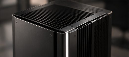 Close detail of the Monolith chassis: machined cooling fins along a brushed metal spine